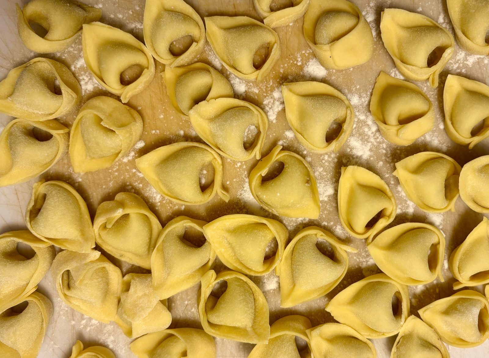Handmade tortellini on a floured board